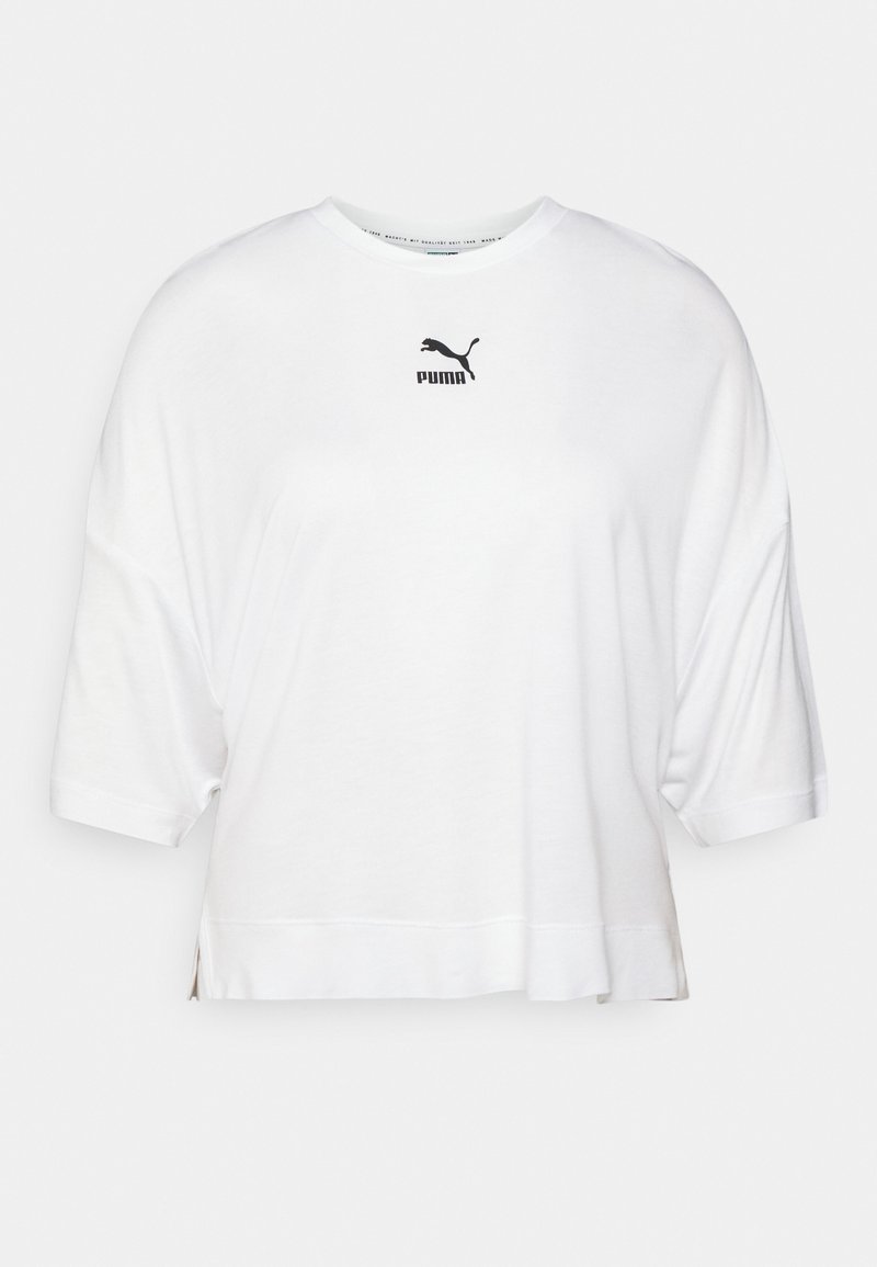 T-shirt bianca cropped realizzata in morbido cotone, con scollatura rotonda e maniche corte. Logo Puma nero in evidenza sul petto.