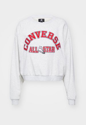 Grey cropped sweatshirt with long sleeves featuring red embroidered "CONVERSE ALL STAR" text and a graphic of a sneaker on the front.