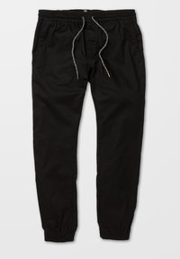Pantalones de chándal negros de algodón con cintura elástica y cordón. Cuenta con puños en los tobillos y bolsillos laterales. Textura suave.