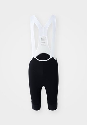 Μαύρα ποδηλατικά σορτς με λευκές διχτυωτές τιράντες, με υφή υφάσματος και μαξιλαρωμένη περιοχή καθίσματος. Μήκους μέχρι το γόνατο με ελαστικά ανοίγματα στα πόδια.