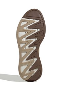 Dno Adidas cipele s smešnim i bež cik-cak uzorkom i teksturiranim područjima za prianjanje.