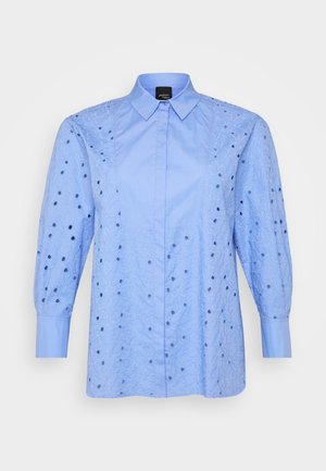 Lichtblauwe shirt met geborduurde bloemenpatronen en uitsparingen. Lange puffmouwen en een klassieke kraag maken het ontwerp compleet.