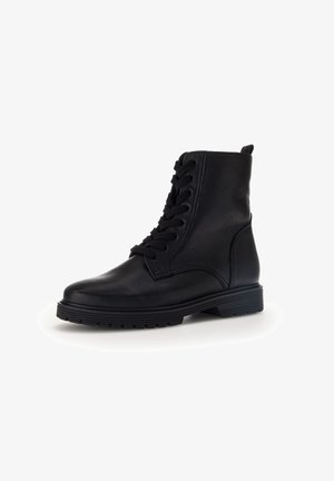 Sort læder ankelstøvle med snørebånd, rund tå og tekstureret gummisål. Har en trækflap og subtile syninger.