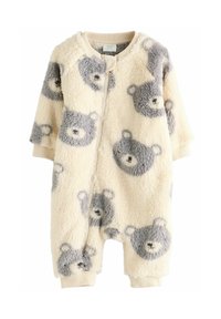 Flis onesie u krem boji s uzorkom sivih medvjedića, prednji zip, rebrasti rubovi i zaobljen dekolte. Mekana tekstura i opušteni kroj.