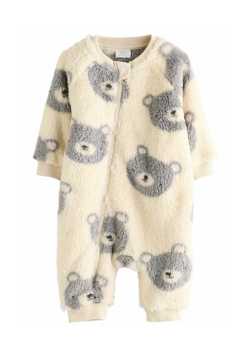 Flis onesie u krem boji s uzorkom sivih medvjedića, prednji zip, rebrasti rubovi i zaobljen dekolte. Mekana tekstura i opušteni kroj.