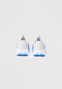 White athletic shoes with blue accents, featuring a textured sole, a smooth upper material, and a pull tab at the heel for easy wear.