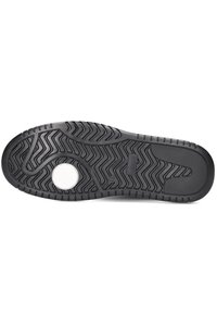 Zwarte rubberen sneakerzool met een gestructureerd zigzagpatroon, cirkelvormige witte accenten en brede grip voor tractie. Glad en flexibel ontwerp.