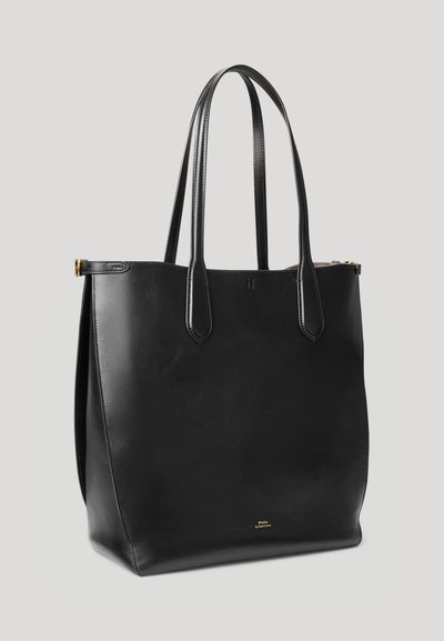 Μαύρη δερμάτινη τσάντα tote με δύο μακριές λαβές, δομημένο σχήμα, διακριτική γυαλάδα και χρυσό λογότυπο στην κάτω εμπρός πλευρά.