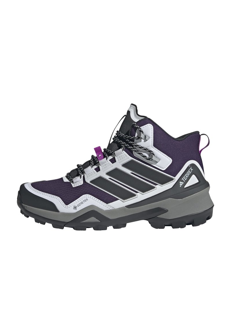 Bottes de randonnée violet et noir avec un design montante, en tissu texturé, matériau Gore-Tex et semelle en caoutchouc robuste dotée de profondes rainures.