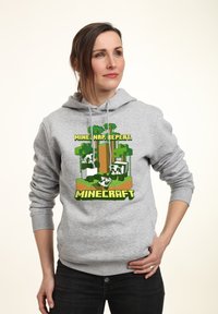 Felpa grigia con cappuccio caratterizzata da una grafica a tema Minecraft con alberi, blocchi e personaggi. Composizione in misto cotone, vestibilità rilassata, polsini a coste.