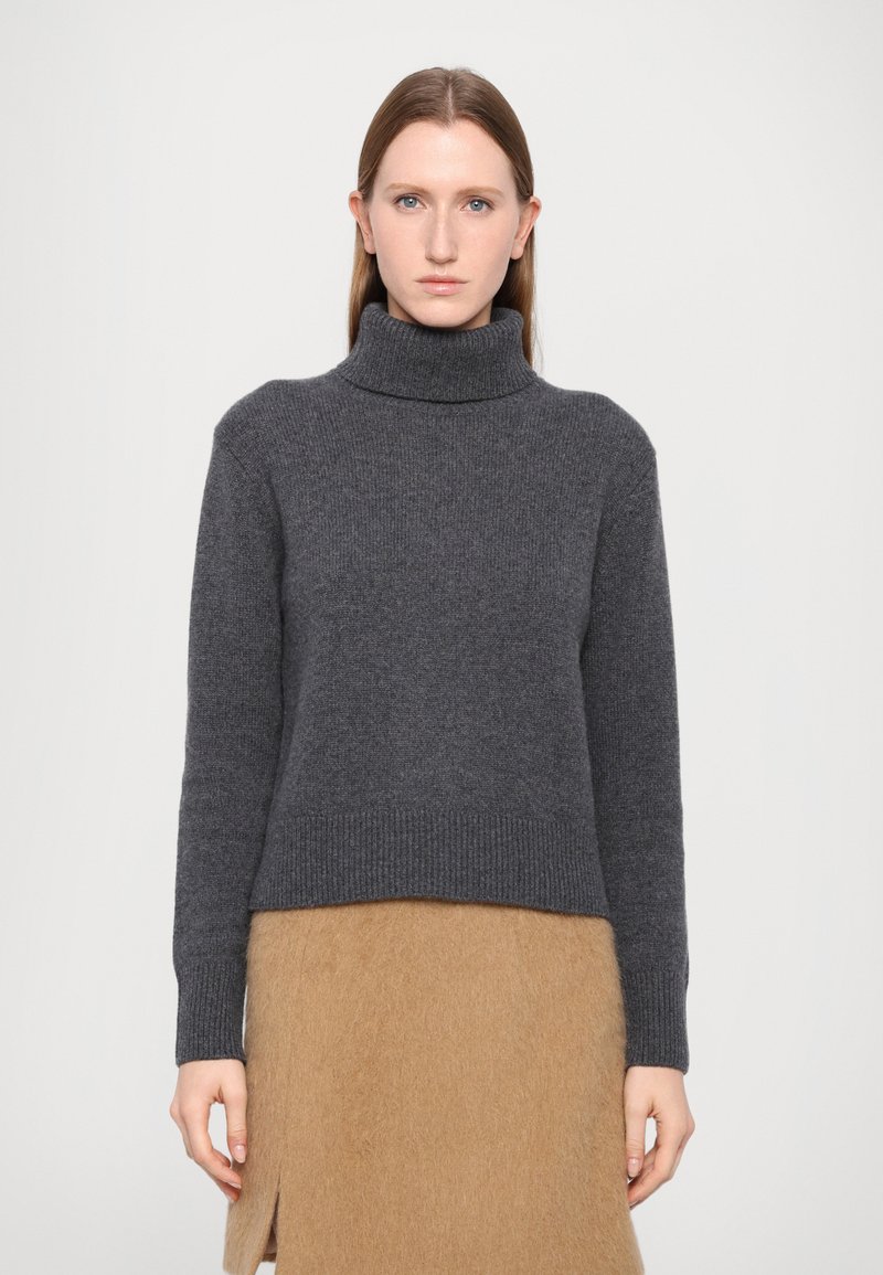 Charcoal gray turtleneck sweater in soft knit fabric with ribbed cuffs and hem, featuring a cropped design and relaxed fit.