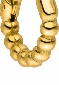 Armbanduhr in Goldfarbe mit runden Perlen, die eine polierte, reflektierende Oberfläche aufweisen. Gleiche und glatte Textur sowie gleichmäßige Form.