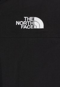 Chemise noire arborant le logo "The North Face" en broderie blanche, avec une texture lisse et sans motifs ni détails matériels visibles.