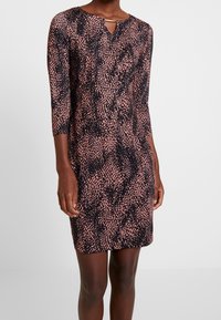 Robe imprimée avec une base noire et un motif éclaboussé rose, manches trois-quarts et un petit col en trou de serrure.