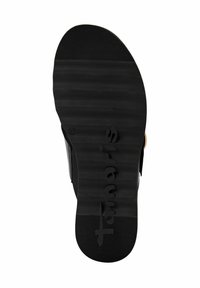 Black rubber shoe sole with ridged texture and embossed brand name. Flat shape designed for comfort and traction.