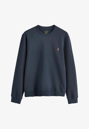 Sudadera de color azul marino hecha de una suave tela de algodón. Presenta un cuello redondo y puños acanalados. Logo bordado en el pecho.