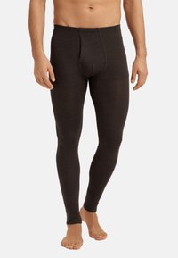 Männer Thermoleggings in Dunkelbraun. Hergestellt aus weichem, dehnbarem Gewebe mit einer glatten Textur und einem figurbetonten Design. Mit einem Eingriff vorne.