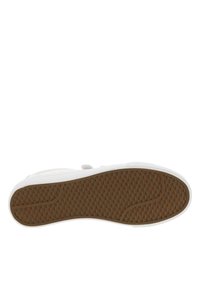 White sneaker with a rubber sole featuring a textured, honeycomb pattern in light brown. Smooth upper with rounded edges and minimal design.