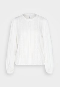 Camicia bianca con maniche a sbuffo lunghe, scollo rotondo, chiusura con bottoni e dettagli in pizzo lungo la parte anteriore e i polsini. Tessuto morbido e testurizzato.