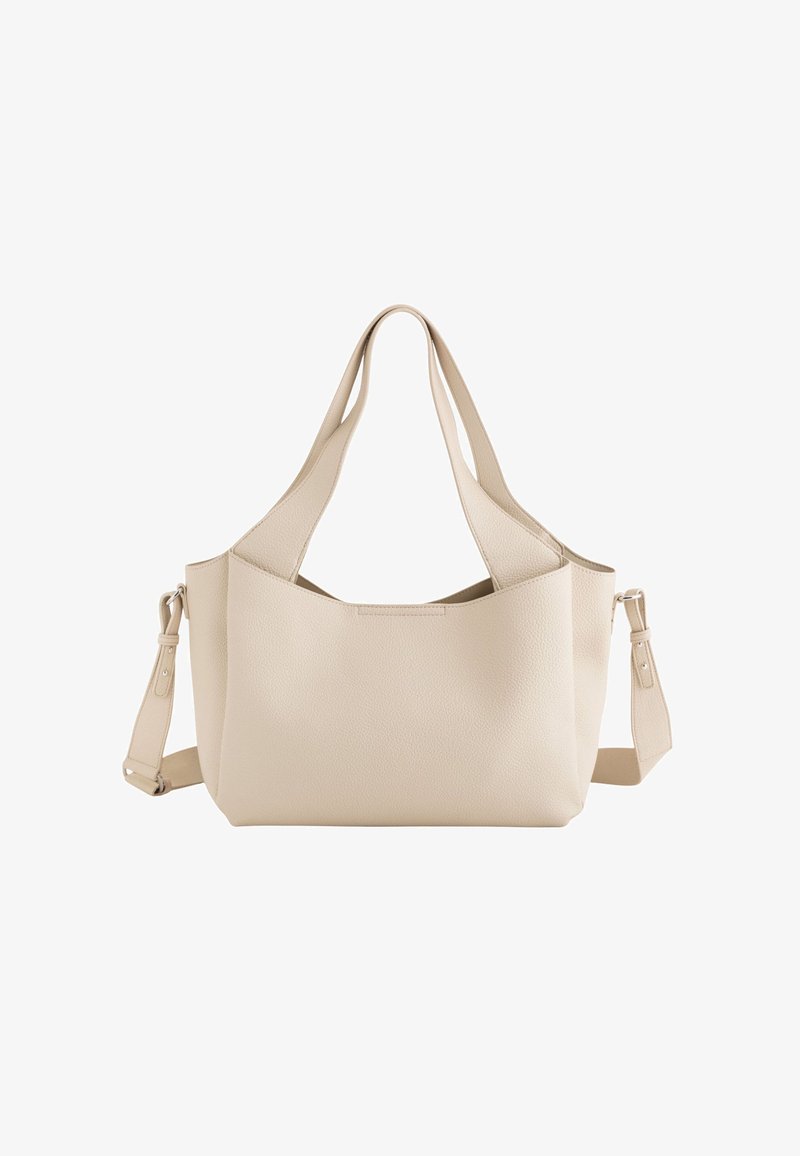 Beige leather tote bag with dual top handles, adjustable shoulder strap, and a minimalist design featuring a textured finish.