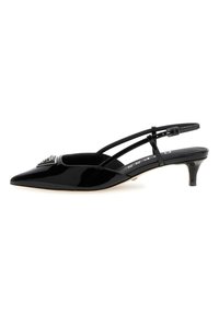Black patent leather slingback heel, pointed toe, thin ankle strap with buckle, small heel, and decorative embellishment on vamp.