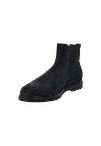 Bottines Chelsea en suède noir avec des panneaux élastiques sur les côtés, bout arrondi et semelle en caoutchouc noir basse.