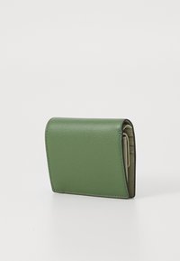 Green leather wallet with a textured finish, compact shape, and stitched edges. Features a fold-over design and interior card slots.
