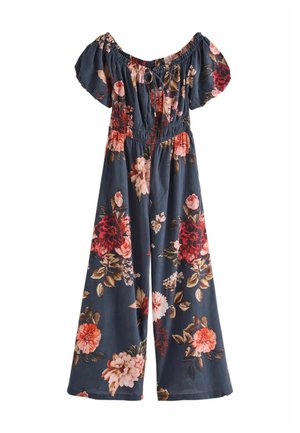 Floral jumpsuit with off-the-shoulder design, dark blue fabric, gathered bodice, and multicolored flower patterns. Wide-leg silhouette.
