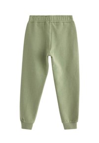 Grønne bomulds-joggers med elastisk talje, tapered ben og ribbede cuffs. Blød tekstur og enkelt design. Ingen lommer.