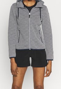 Giacca con cappuccio e zip, con un motivo geometrico bianco e nero, dotata di tasche, bordo a contrasto, tessuto texturizzato e maniche lunghe.
