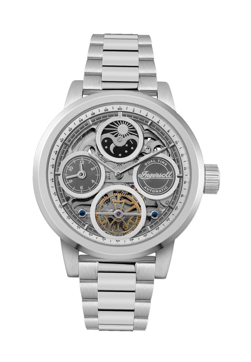 Montre en acier inoxydable argenté avec un cadran squeletté, affichage de l'heure double, engrenages complexes et un bracelet en métal texturé.