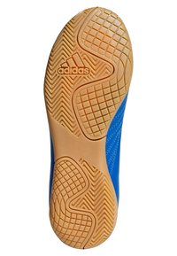 Blue athletic shoe with a textured outsole featuring a rubber design and Adidas logo, contrasting with the orange-brown color of the sole.