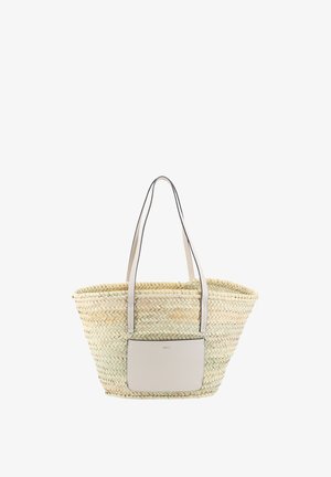 Woven straw tote bag with long beige leather handles and a beige front pocket, set against a white background.