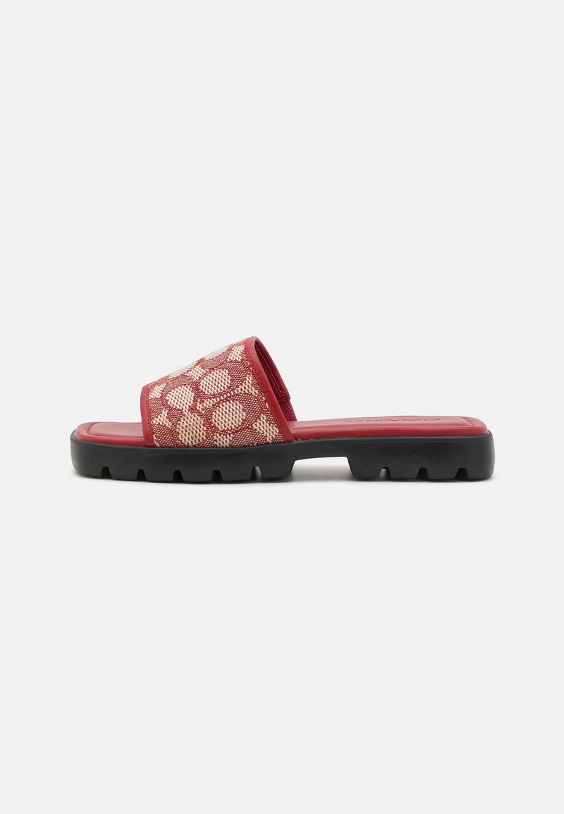 Sarkans slide sandal ar teksturētu augšdaļu ar Apaļiem motīviem, mīkstu zoli un izturīgu melnu gumijas zoli.