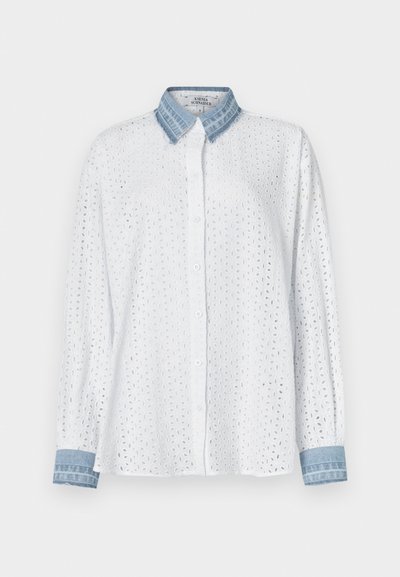 White, long-sleeve shirt with eyelet pattern and denim collar. Button-down front and denim cuffs; lightweight fabric, casual design.