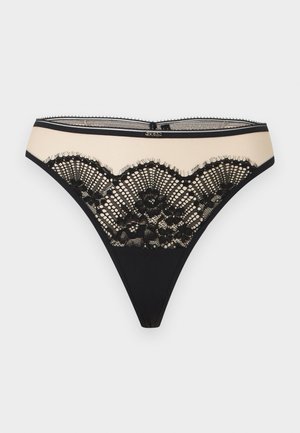 Μπεζ και μαύρο διαφανές εσώρουχο με δαντέλα, με διακοσμητική δαντέλα με κυματοειδές μοτίβο και μικρό μεταλλικό λογότυπο στο κέντρο της μέσης.