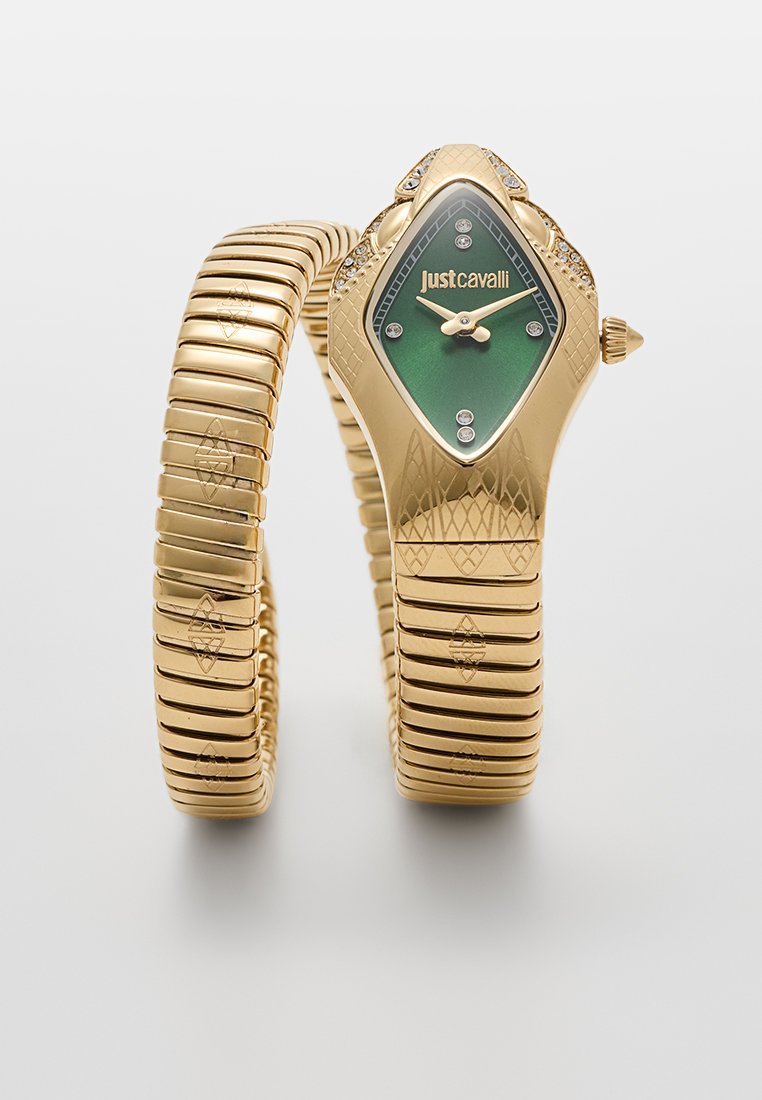 Montre extensible dorée avec un cadran vert en forme de diamant, dotée d'aiguilles dorées et de six strass. Bracelet doré texturé avec des motifs décoratifs.