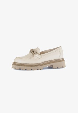 Beige leather loafer with a textured cream band and decorative hardware. Chunky beige sole with a rugged tread design for traction.