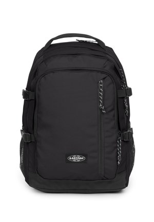Black fabric backpack with padded back, adjustable straps, multiple zippered compartments, and mesh pockets on the sides. Eastpak logo present.