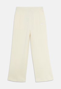 Sweat hlače širokega kroja v off-white barvi z elastiko v pasu, stranskimi žepi in majhnim belim logotipom Nike na levi stegn.