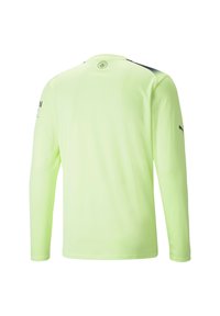 Langærmet skjorte i fluorescerende gul stof med en glat tekstur, med sorte detaljer ved skuldrene og logo ved halsen.