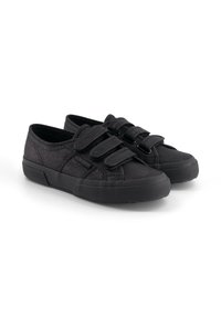 Sneakers con cinturino in velcro nero, dotati di tomaia in tessuto texture, suola in gomma e punta rotonda, caratterizzati da un design a bassa altezza e senza marchio visibile.