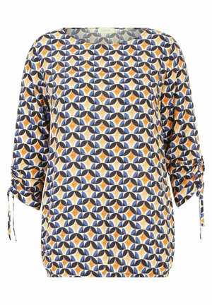Losse blouse met een ronde hals. Gekenmerkt door een geometrisch patroon in blauw, oranje en crème. Elastische mouwen met strikaccenten.