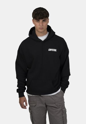 Felpa Calvin Klein nera a maniche lunghe con cappuccio e logo bianco Felpa Calvin Klein nera a maniche lunghe con cappuccio e logo bianco