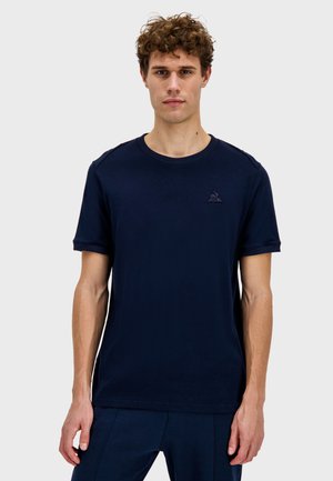 Navy blue, short-sleeve t-shirt in cotton with a round neckline. Features a small logo on the chest and clean, simple lines.
