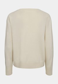 Maglione color crema con scollo rotondo, maniche lunghe a raglan e polsini e orlo a coste. Tessuto morbido e testurizzato, design semplice senza decorazioni.