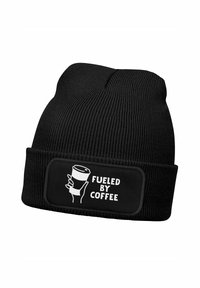 Black knit beanie with ribbed texture and a folded cuff. Features a rectangular patch with white text "FUELED BY COFFEE" and a coffee cup illustration.