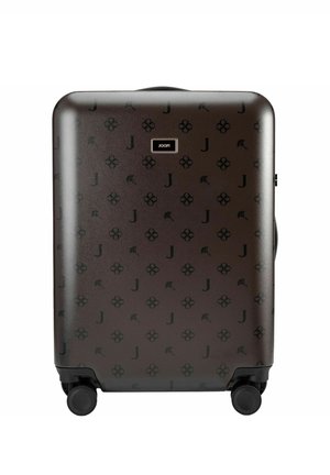Hard-shell brown suitcase with black floral and "J" pattern, four spinner wheels, and a centered "JOOP!" logo plaque.