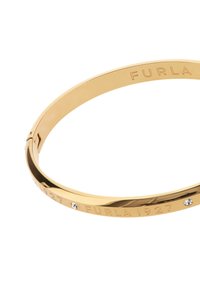 Kuldtona käevõru, millel on graveeritud tekst "FURLA 1927" ning kolm väikest selget kristalli. Sile, poleeritud metallpind.