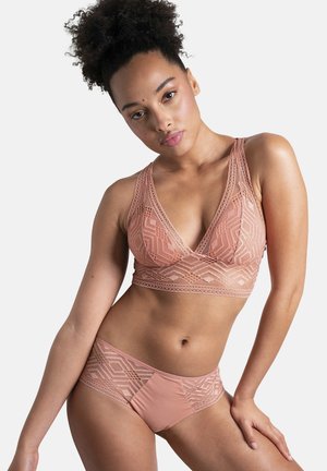 Lace bralette and matching bikini in soft rose with geometric patterns; textured design, adjustable straps, and mid-rise cut.